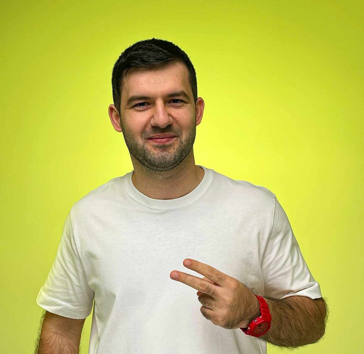 A man in a white shirt pointing at something