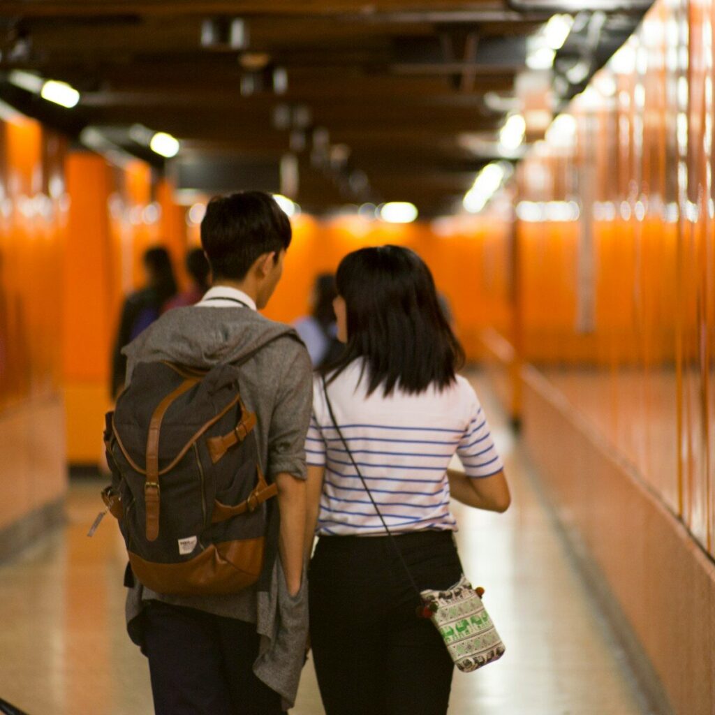 two people walking inside building